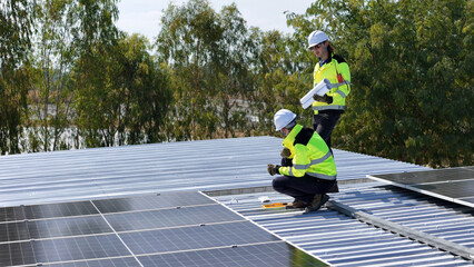 Workers Installing Solar Panels on a Rooftop in Sunny Weather