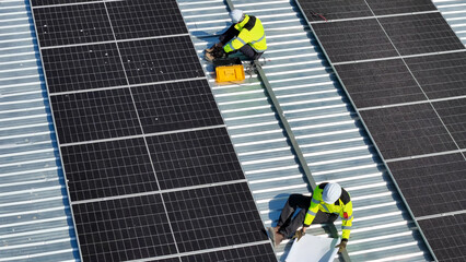 Installation of Solar Panels on a Rooftop by Workers in Safety Gear During Daylight