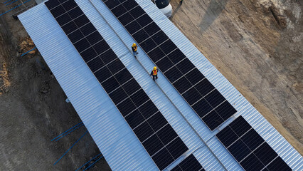 Solar Panel Installation on Rooftop by Workers at a Construction Site in Daylight