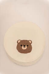Small bento cake decorated with cute head teddy bear silhouette. Cake as a gift. Bento cake for celebration day. A small cake with a picture or a congratulation for one person. Top view.