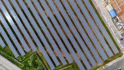 Expansive solar panel array captured from above in a clear sky