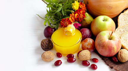 Autumn fruits with honey of the new harvest for a healthy eating concept.