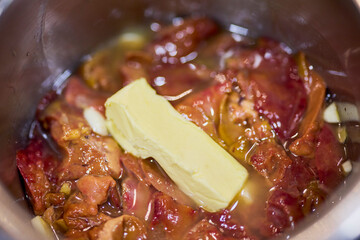 a pan with chicken livers and garlic on the stove to cook