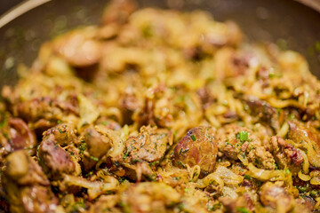 a pan with chicken liver, onion, garlic and dill
