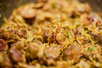 a pan with chicken liver, onion, garlic and dill