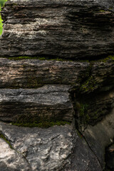 Layered Rock Formation With Moss And Green Patterns