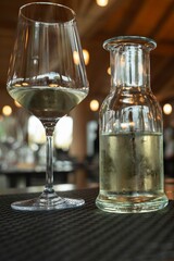 Close-Up of White Wine Glass and Chilled Bottle in a Stylish Setting