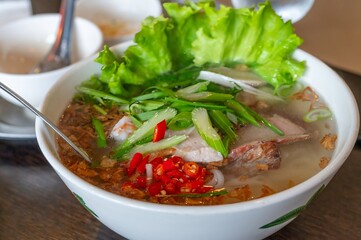 Vietnamese Pho Noodle Soup with Fresh Herbs, Chili, and Sliced Pork