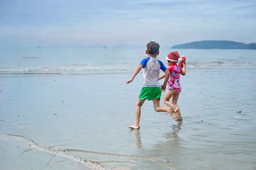kids in Santa hat on the beach