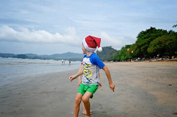kids in Santa hat on the beach