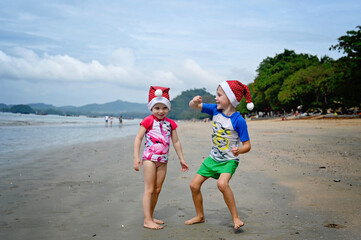 kids in Santa hat on the beach