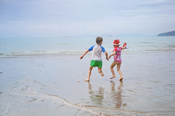 kids in Santa hat on the beach