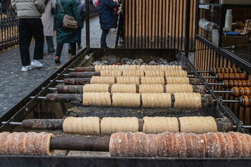 Cooking "trdelnik" (traditional Czech pastry) at a Christmas fair in Prague, Czech Respublic.