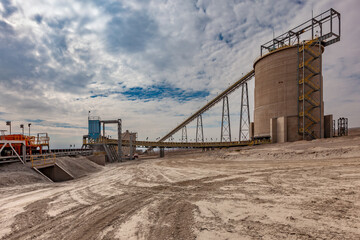 Fototapeta premium Conveyor belt and processing plant at an open-pit copper mine in Chile.