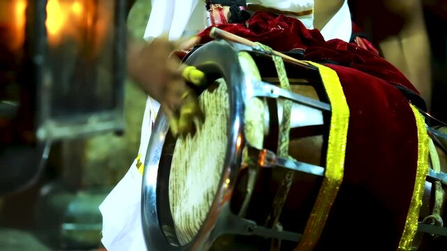 Tawil drum: street musician plays traditional Indian tawil drum. Mysore, India.