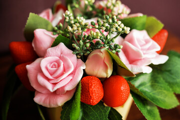 Handmade soap bouquet in a dark key. Composition artificial plants and branches and buds of flowers and berries from soap.