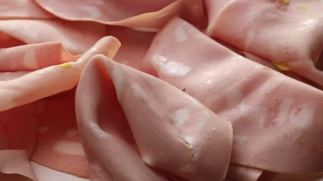 Mortadella with pistachio, rotation in circle. traditional Italian Bologna meat, Turning. classic Italian deli meat with pistachio