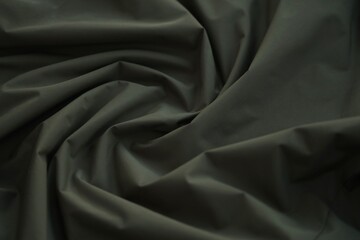 Fototapeta premium Texture of Dark green military uniform textile cloth with folds