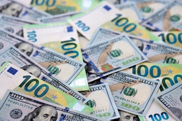 Big pile of Euro and USD banknotes. Many european and united states dollars