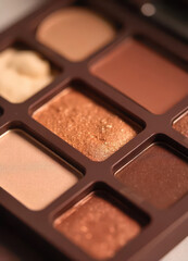 Fototapeta premium Create stunning makeup looks with warm tone eyeshadow palette makeup studio photography indoor close-up