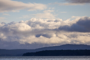Obraz premium Scenic View of Clouds Over Hills and Water in Canada