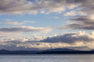 Obraz premium Serene Landscape of Vancouver Island With Dramatic Cloudy Sky and Calm Waters
