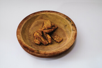 Delicious fried tempeh or fried tempeh is ready to eat, with a white background.