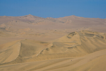 Expansive golden sand dunes of the Ica desert near Huacachina Oasis with breathtaking natural views in Peru