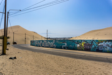 Huacachina Oasis surrounded by golden sand dunes in the Ica desert Peru