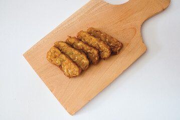 Delicious fried tempeh or fried tempeh is ready to eat, with a white background.