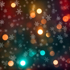 colorful bokeh lights with falling snowflakes on festive dark background
