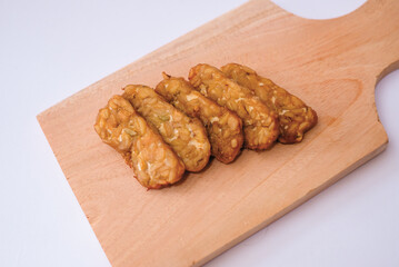 Delicious fried tempeh or fried tempeh is ready to eat, with a white background.