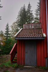 the elements of a red norwegian house on a rainy day