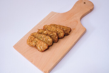 Delicious fried tempeh or fried tempeh is ready to eat, with a white background.