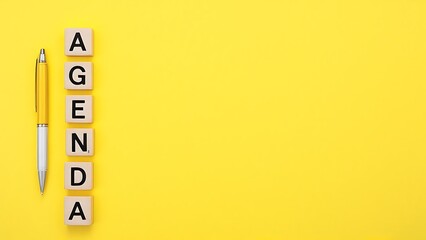 Agenda word on yellow background with copy space for text.
