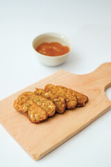 Delicious fried tempeh or fried tempeh is ready to eat, with a white background.