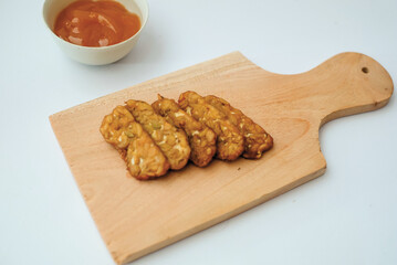 Delicious fried tempeh or fried tempeh is ready to eat, with a white background.