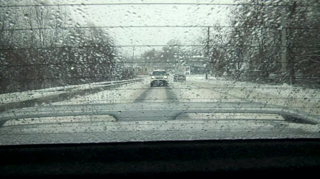 View from the rear window of a car onto the road.