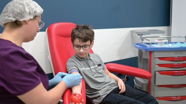 A nurse takes blood from a child using butterfly needle. Close up view during of taking a blood sample for examination in a modern laboratory or hospital. Baby health check