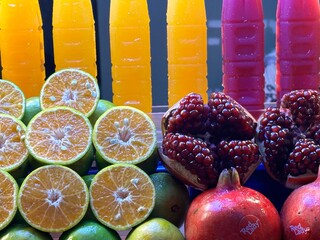 A variety of fruits and refreshing juices are on the table