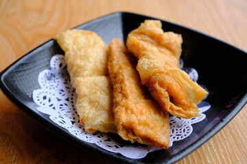 Fried Chinese Traditional Spring rolls food in ceramic plate.