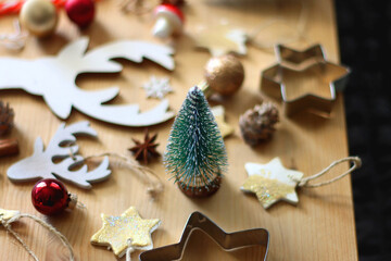 Various Christmas decorations in neutral colors on wooden background. Selective focus.