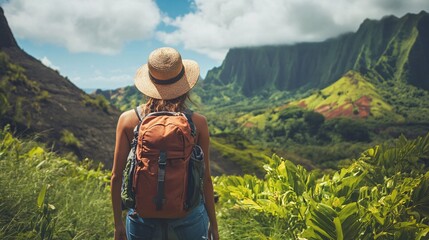 Tourist enjoying breathtaking view of hawaiian mountains covered by lush vegetation
