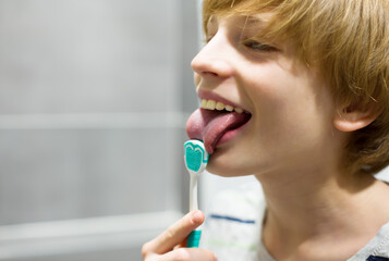 Child Using a Tongue Cleaner for Oral Hygiene