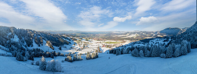 wintry panoramic aerial view of the snow covered alpine landscape with the Oberstaufen-Steibis...