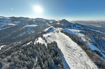 wintry panoramic aerial view of the snow covered alpine landscape of the Nagelfluh mountain chain...