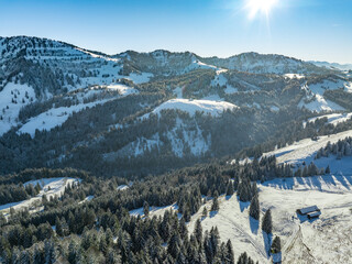 wintry panoramic aerial view of the snow covered alpine landscape of the Nagelfluh mountain chain...