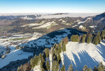 wintry panoramic aerial view of the snow covered alpine landscape of the Nagelfluh mountain chain...