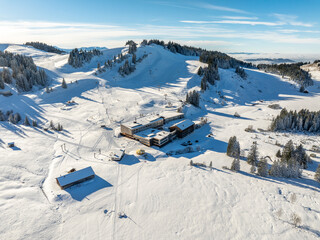wintry aerial photo of the Hochhaedrich ski area and resort in the Bregenz Forest mountains next to Hittisau, Vorarlberg, Austria