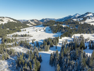 wintry panoramic aerial view of the snow covered alpine landscape of the Nagelfluh mountain chain...
